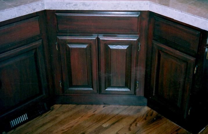 Faux Cherry guestroom cabinet finish
